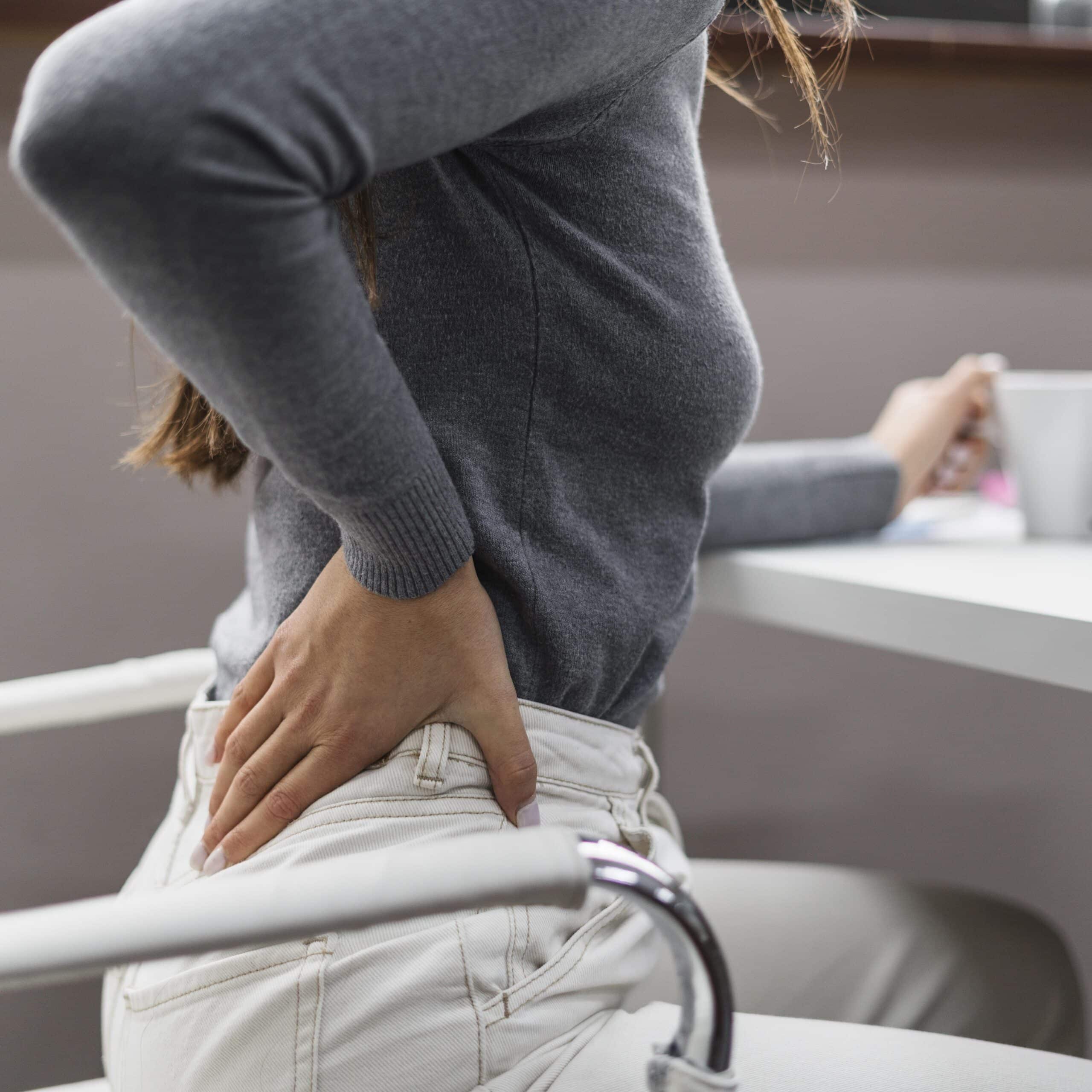 sideways-woman-having-backache-while-working-from-home woman having a backache